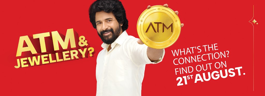 ATM & Jewellery? What's the connection? Find out on 21st August. Man holding a gold ATM coin.